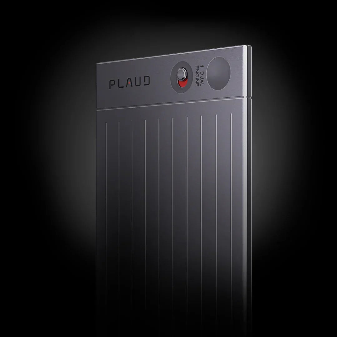 Card-shaped dark gray Plaud AI voice recorder with vertical ridges and a dual engine switch.