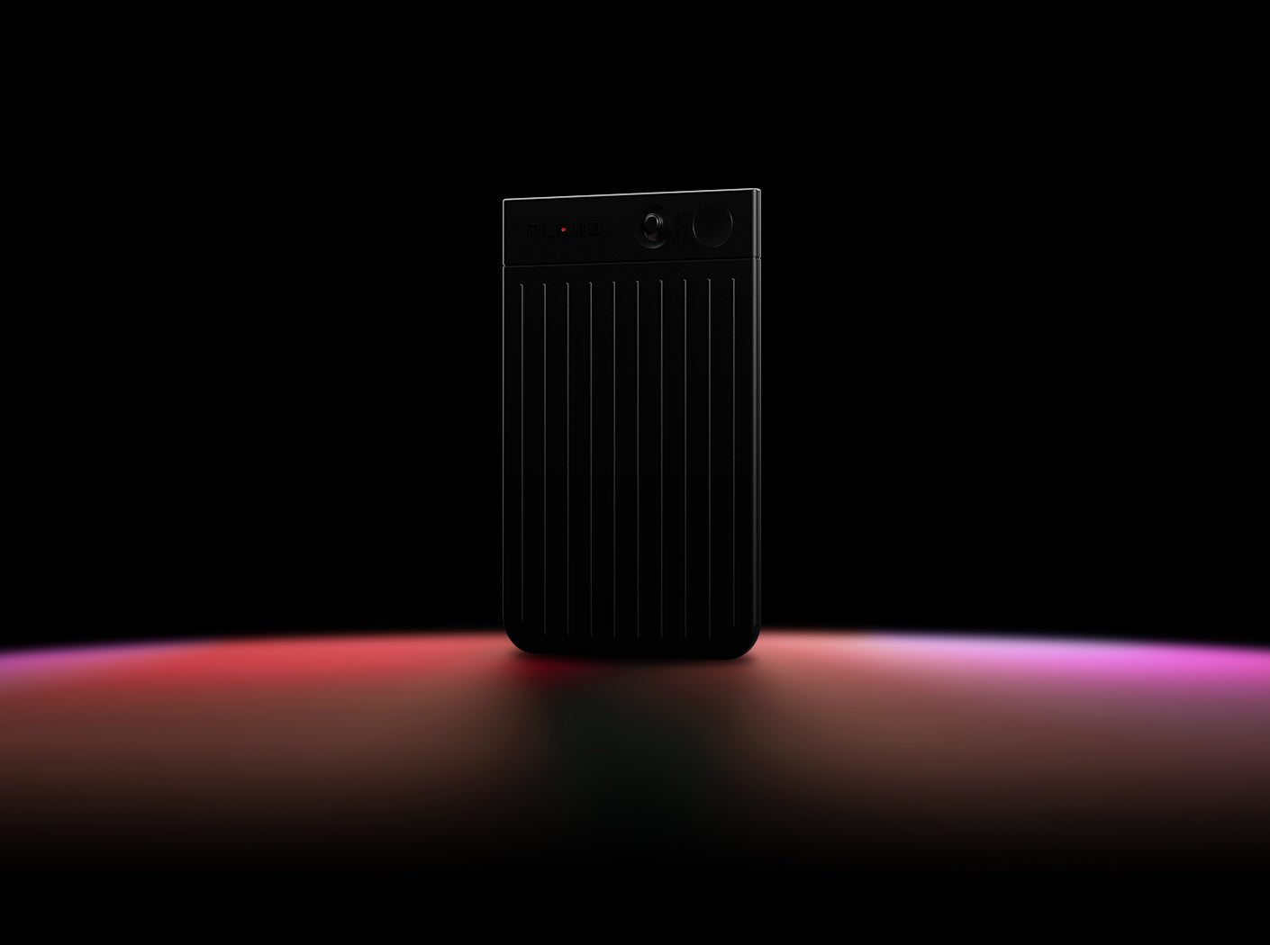 Black Plaud Note Pro AI voice recorder with a ribbed texture and display screen on a dark background.