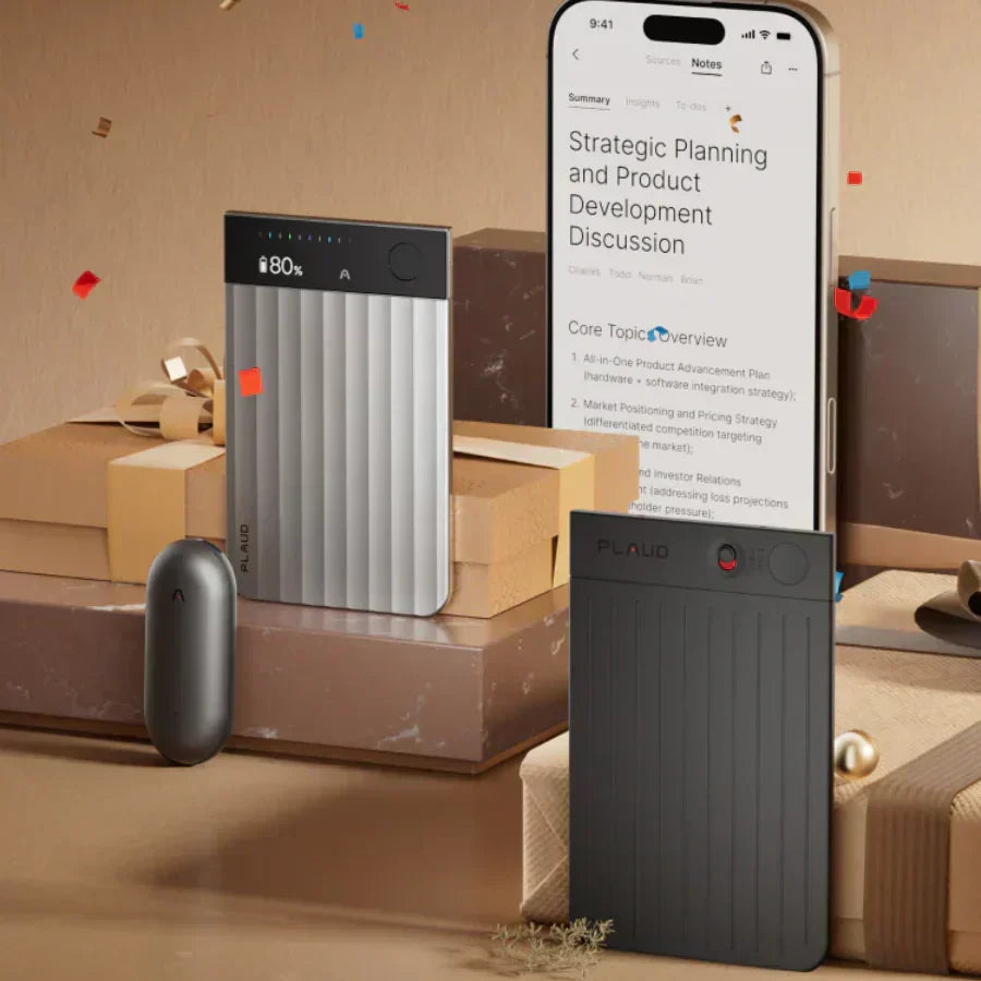 Silver and black Plaud Note Pro recorders and a gray Plaud NotePin with a phone showing the Plaud App among gift boxes.