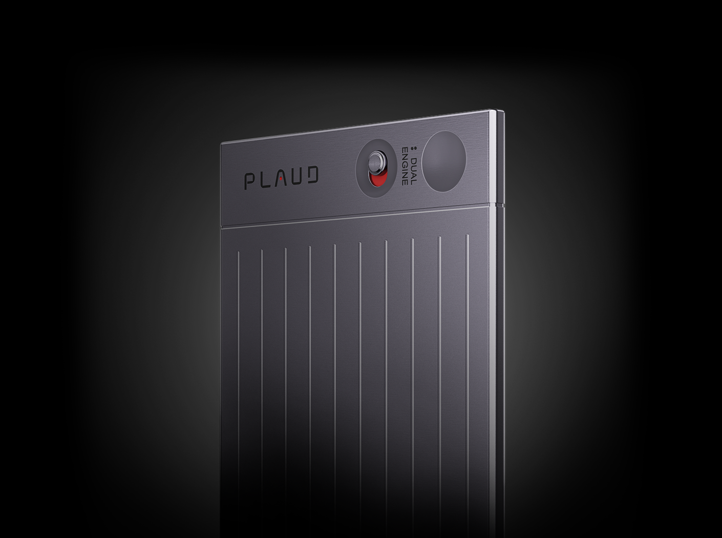 Close-up of the gray Plaud Note AI voice recorder showing the dual engine switch and vertical ribbed texture.
