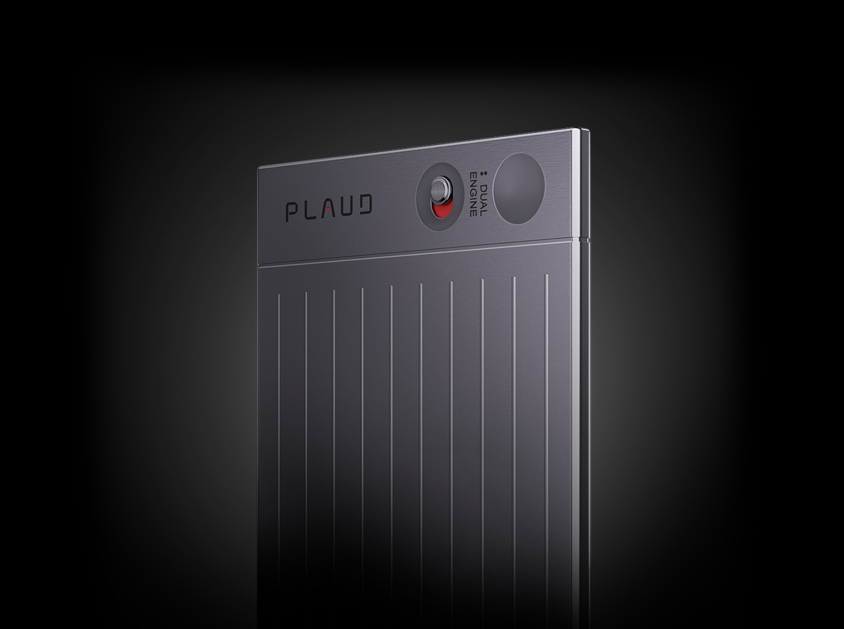 Close-up of the gray Plaud Note AI voice recorder showing the dual engine switch and vertical ribbed texture.