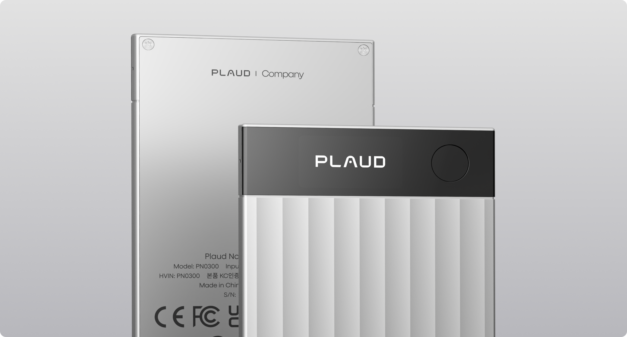Silver Plaud Note Pro with ribbed texture in front of a smooth silver Plaud Note.
