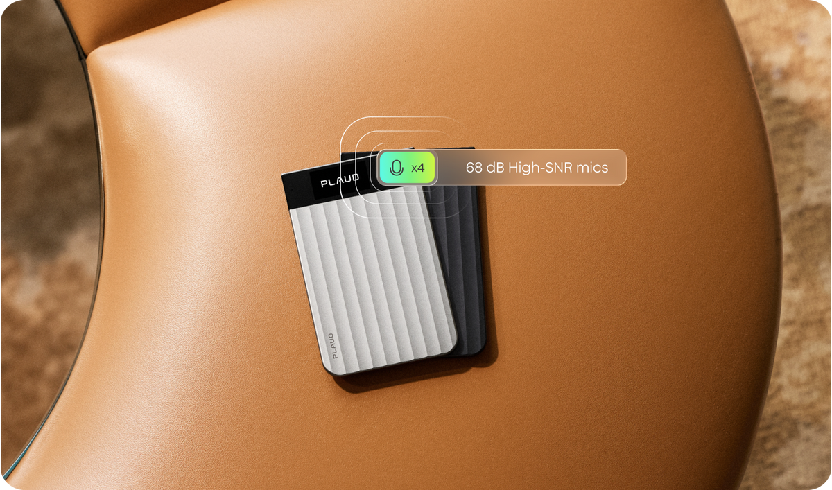 A silver and a black Plaud Note Pro rest on a tan leather surface, with a label highlighting four 68 dB high-SNR microphones.
