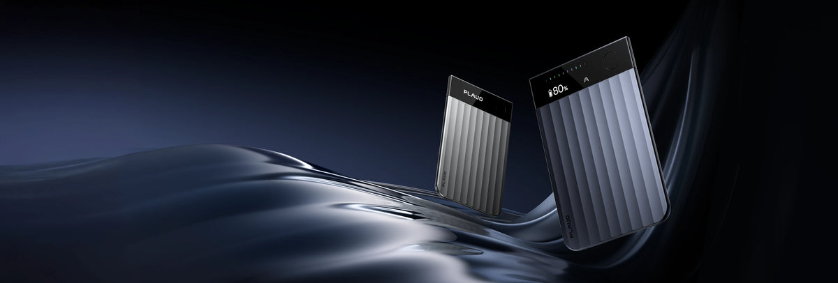 Silver and navy blue Plaud Note Pro recorders with ribbed textures and display screens on a dark wavy background.